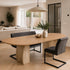 eettafel deens ovaal dualis in een woonkamer  met bank en stoel eraan geschoven.