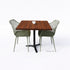 Bartafel met zwart metalen onderstel en warm bruin douglas blad, gecombineerd met groene kuipstoelen.